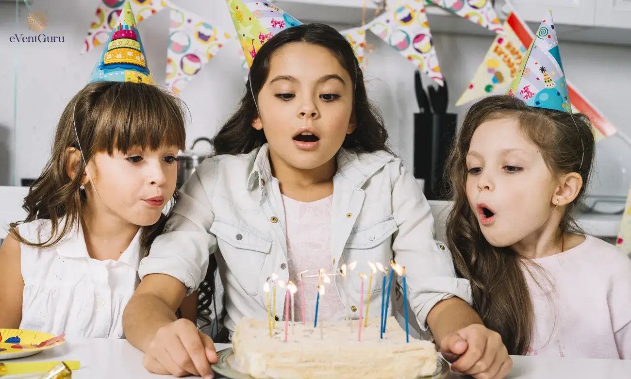 At a birthday party, three pretty girls blow candles on a cake.